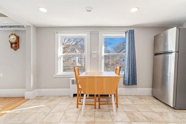 dining room featuring recessed lighting, radiator heating unit, baseboards, and light tile patterned floors