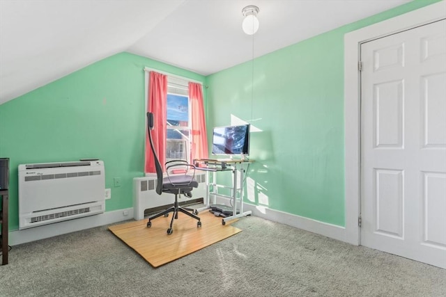 carpeted office featuring lofted ceiling, radiator, baseboards, and heating unit