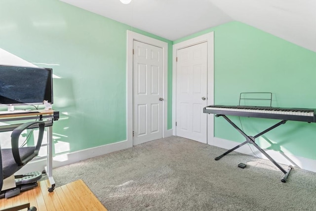 carpeted office with baseboards and vaulted ceiling