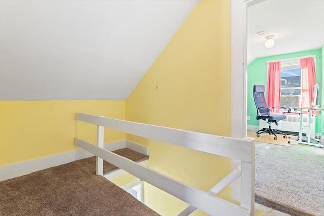 bonus room featuring lofted ceiling, carpet, and baseboards