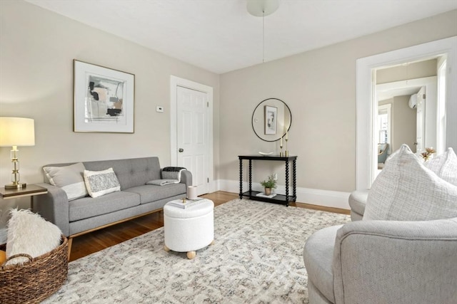 living area featuring wood finished floors and baseboards