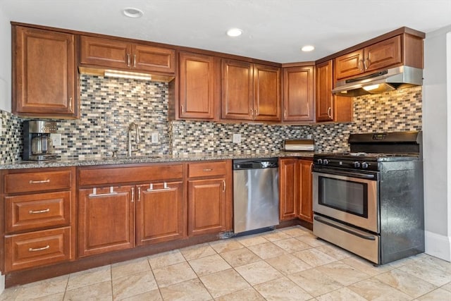 kitchen featuring sink, decorative backsplash, light tile patterned flooring, light stone counters, and stainless steel appliances