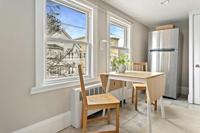 dining room featuring baseboards and radiator