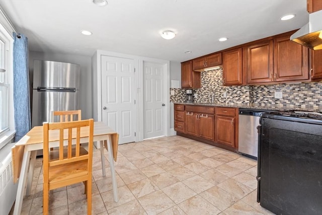 kitchen featuring stainless steel appliances, brown cabinetry, decorative backsplash, and under cabinet range hood