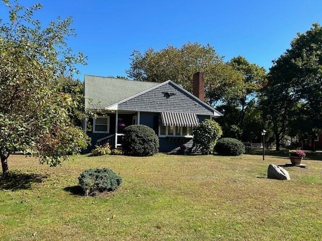 view of side of property with a lawn