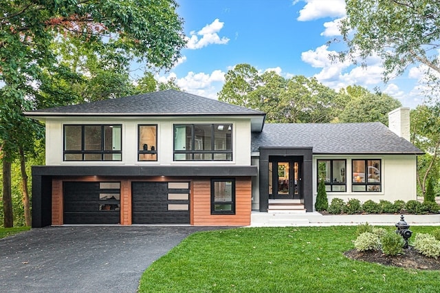 view of front facade featuring a garage and a front lawn