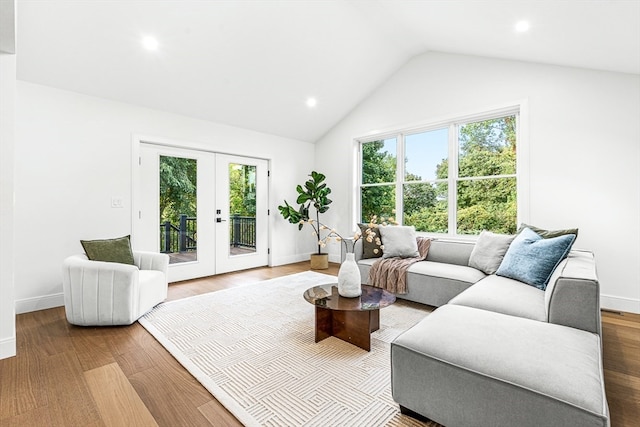 living room featuring french doors, vaulted ceiling, and wood-type flooring