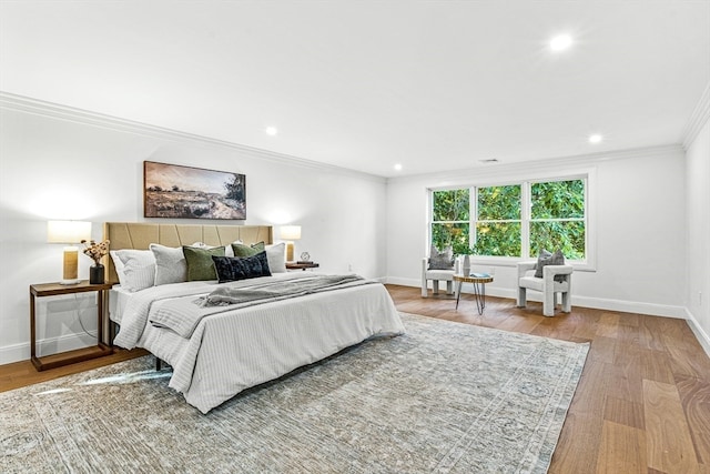 bedroom with light hardwood / wood-style floors and ornamental molding