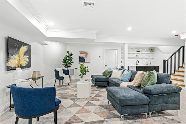 living room with bar and crown molding