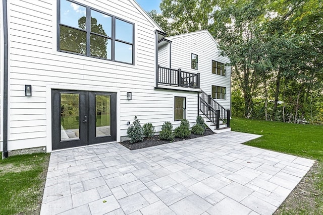 back of property featuring a yard and a patio area