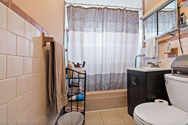 bathroom with toilet, shower / bath combo, tile walls, and vanity