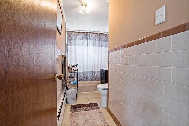 full bath with tile walls, baseboard heating, toilet, shower / tub combo, and tile patterned floors