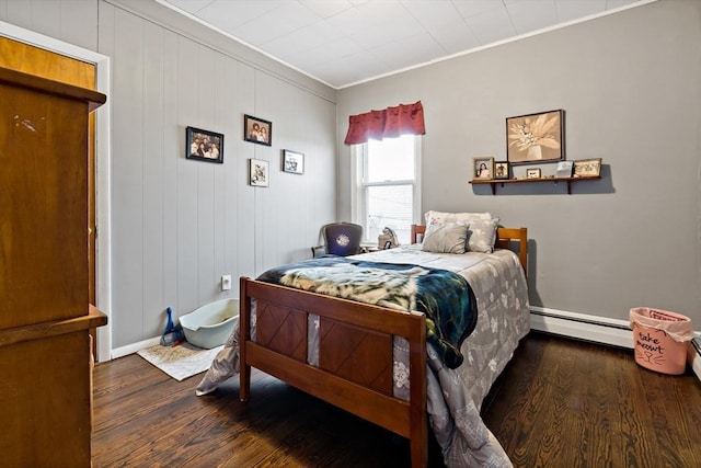 bedroom featuring baseboards, a baseboard radiator, ornamental molding, and wood finished floors