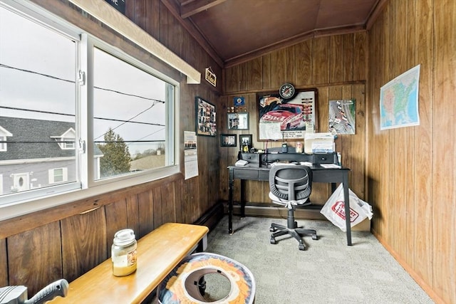 office featuring vaulted ceiling, carpet flooring, and wood walls