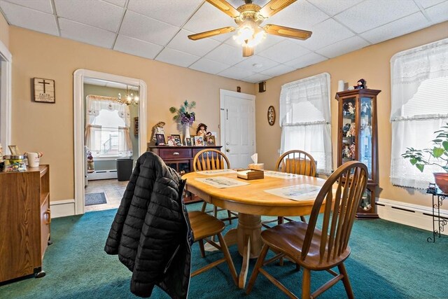 dining room featuring carpet floors, a baseboard radiator, ceiling fan, and a drop ceiling