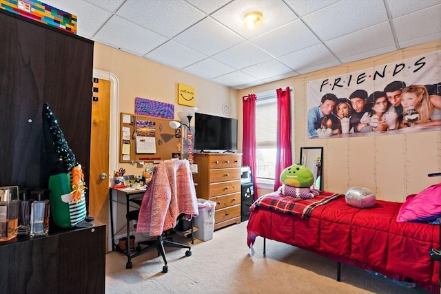 carpeted bedroom with a paneled ceiling