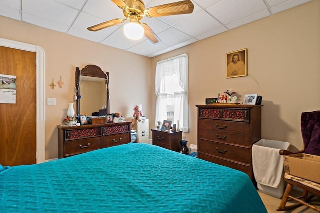 bedroom with a ceiling fan and a paneled ceiling