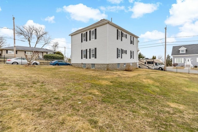 view of home's exterior with a yard and fence