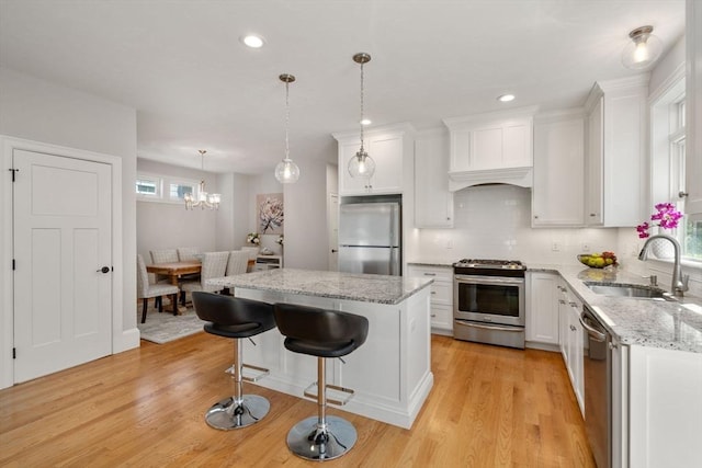 15 Boydes Xing Unit 13, Norfolk, MA 02056 - kitchen featuring appliances with stainless steel finishes, a sink, plenty of natural light, light wood-style floors, and recessed lighting