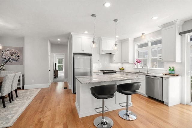 15 Boydes Xing Unit 13, Norfolk, MA 02056 - kitchen with appliances with stainless steel finishes, a sink, a center island, white cabinets, and recessed lighting