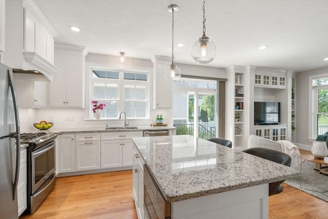 15 Boydes Xing Unit 13, Norfolk, MA 02056 - kitchen with appliances with stainless steel finishes, a sink, a kitchen island, open floor plan, and white cabinets