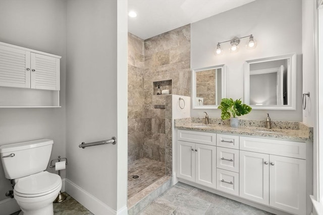 15 Boydes Xing Unit 13, Norfolk, MA 02056 - full bathroom featuring double vanity, tiled shower, baseboards, and toilet