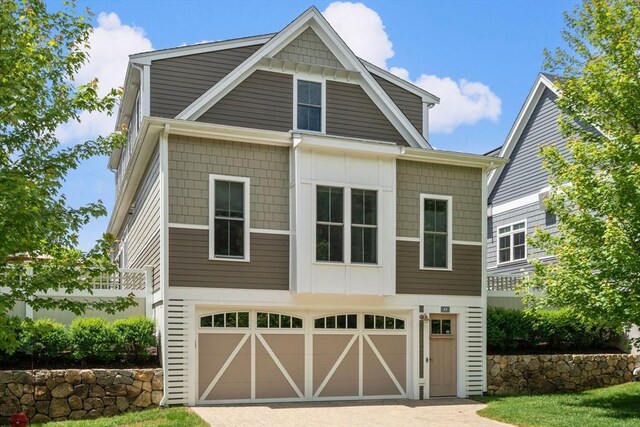 15 Boydes Xing Unit 13, Norfolk, MA 02056 - view of front of home with board and batten siding, an attached garage, and driveway