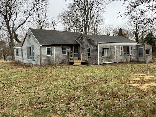 rear view of house featuring a yard