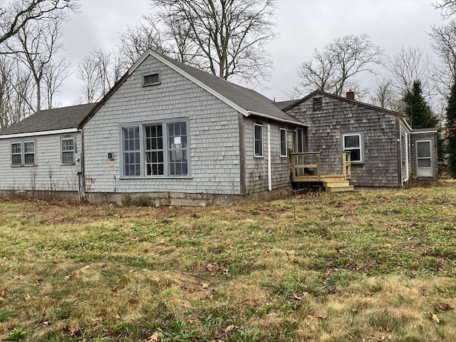 back of house with a lawn