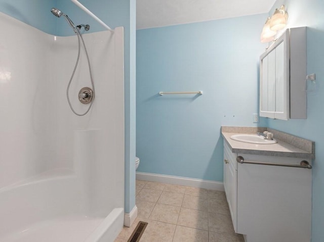 full bathroom with a shower, vanity, tile patterned floors, and baseboards