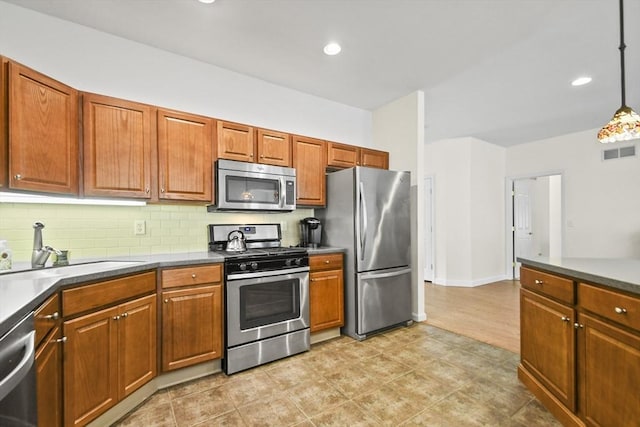 28 Summerfield Dr Unit 28, Grafton, MA 01560 - kitchen with appliances with stainless steel finishes, a sink, decorative backsplash, decorative light fixtures, and brown cabinets