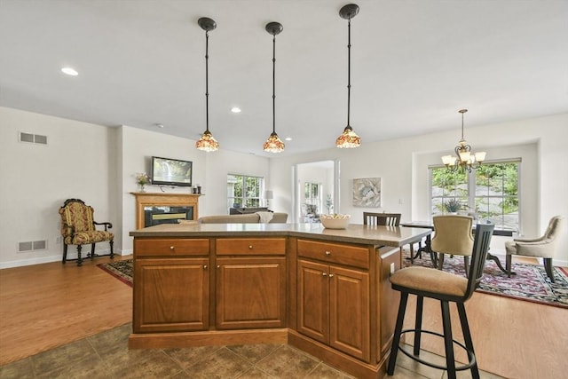 28 Summerfield Dr Unit 28, Grafton, MA 01560 - kitchen with a kitchen island, healthy amount of natural light, a high end fireplace, decorative light fixtures, and recessed lighting