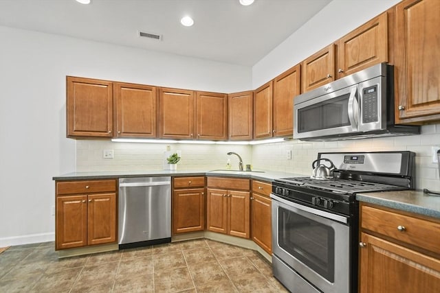 28 Summerfield Dr Unit 28, Grafton, MA 01560 - kitchen with stainless steel appliances, a sink, decorative backsplash, brown cabinets, and recessed lighting