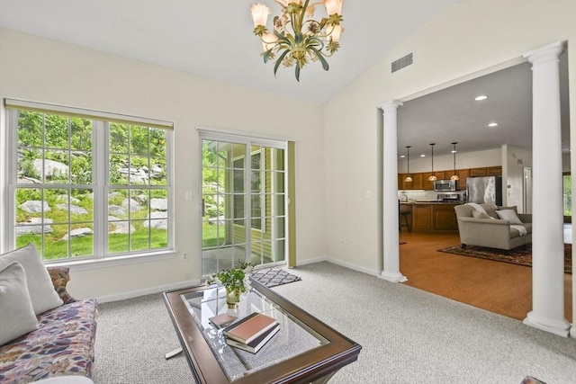 28 Summerfield Dr Unit 28, Grafton, MA 01560 - living area featuring decorative columns, light carpet, a chandelier, lofted ceiling, and baseboards