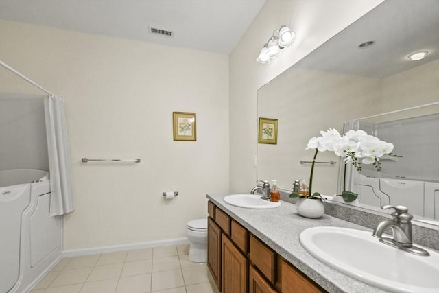 28 Summerfield Dr Unit 28, Grafton, MA 01560 - bathroom featuring toilet, double vanity, baseboards, and tile patterned floors