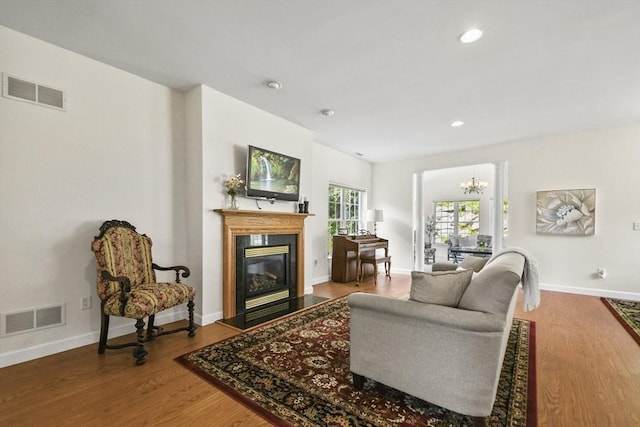 28 Summerfield Dr Unit 28, Grafton, MA 01560 - living room featuring a chandelier, baseboards, a glass covered fireplace, wood finished floors, and recessed lighting