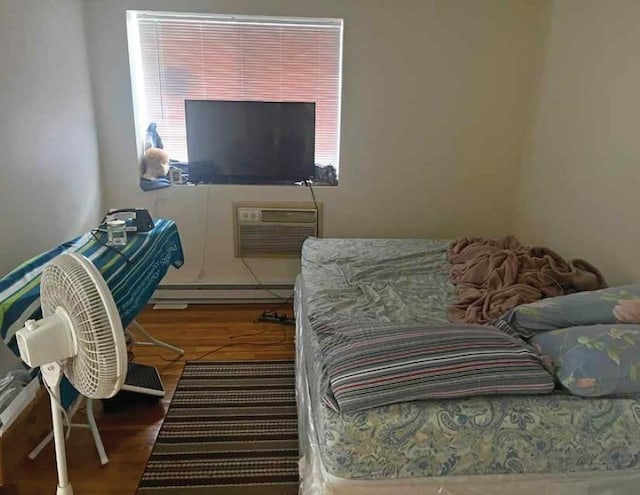447 Pleasant St, Melrose, MA 02176 - bedroom with wood finished floors, a baseboard radiator, and a wall mounted AC