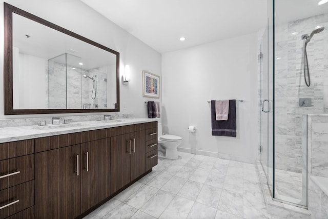 bathroom featuring a shower with door, vanity, and toilet