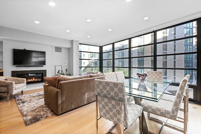 dining space featuring light hardwood / wood-style flooring and expansive windows