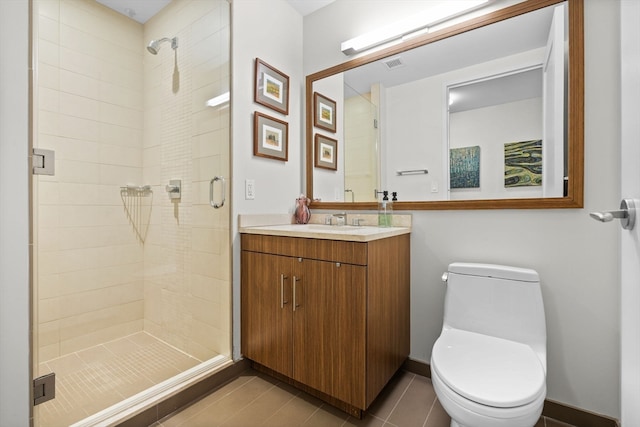 bathroom featuring tile patterned flooring, vanity, an enclosed shower, and toilet