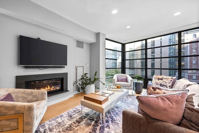 living room with expansive windows and light wood-type flooring