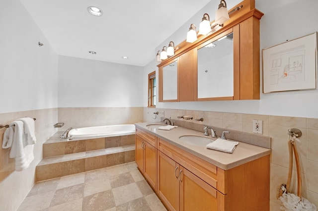 bathroom with vanity and tiled bath