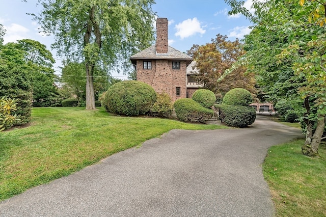 view of property exterior featuring a lawn