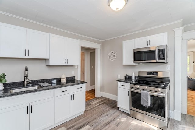 229 Saint James Blvd, Springfield, MA 01104 - kitchen featuring stainless steel appliances, a sink, light wood-type flooring, white cabinets, and crown molding