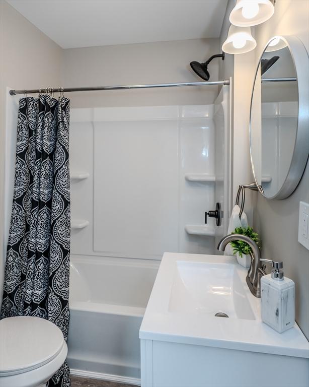 229 Saint James Blvd, Springfield, MA 01104 - bathroom with shower / bathtub combination with curtain, toilet, and vanity