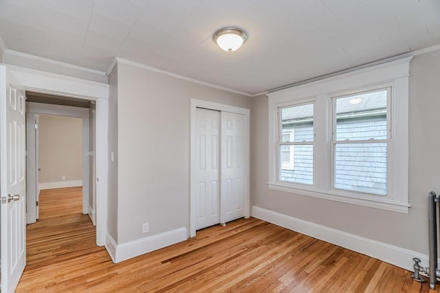 229 Saint James Blvd, Springfield, MA 01104 - unfurnished bedroom with light wood finished floors, baseboards, ornamental molding, and a closet