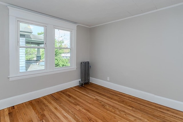 229 Saint James Blvd, Springfield, MA 01104 - spare room featuring radiator heating unit, baseboards, light wood-type flooring, and crown molding