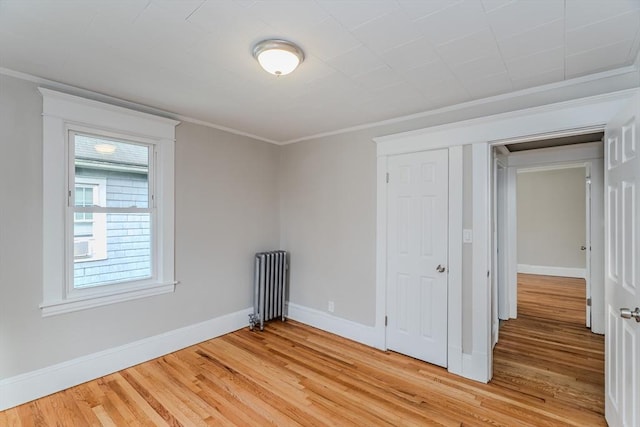 229 Saint James Blvd, Springfield, MA 01104 - unfurnished room with radiator, light wood-style flooring, baseboards, and crown molding