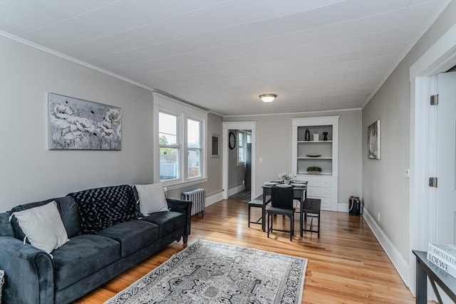 229 Saint James Blvd, Springfield, MA 01104 - living room featuring radiator, built in features, ornamental molding, light wood finished floors, and baseboards