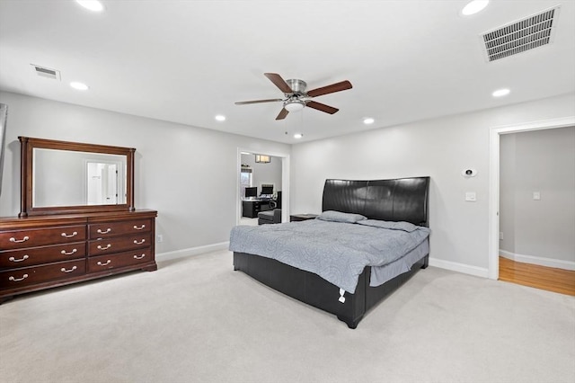 bedroom featuring light colored carpet, recessed lighting, and visible vents